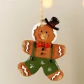 Gingerbread man resin ornament with black hat, red bow, and green trousers for Christmas tree - Overall Gingerbread Man
