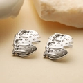 Irregular geometric silver studs with zircon inlays on natural stone background - Silver