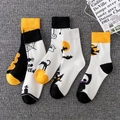 Halloween crew socks featuring black cats and spider webs on a textured background - Unisex (35-44) / Halloween Themed Trendy Socks (Mixed)