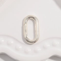 Macro shot of silver oval spring clasp connector on a white ceramic tray for jewelry making - Type C: Silver Oval