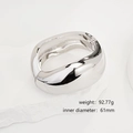 Polished silver minimalist irregular open bangle shown on a white stone base - Polished Chunky Silver Open Bangle (SL227) / Silver