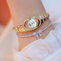 Luxury gold quartz watch with diamond accents and silver bow bracelet on wrist - Gold Watch Bracelet Set