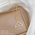 Detailed view of a gold whale tail necklace with sparkling micro-pave crystals - Gold Whale Tail Zirconia Style (A108)