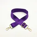 Detail of adjustable purple nylon shoulder strap with gold metal hooks and textured weave - Purple
