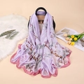 Elegant floral print satin silk scarf draped over a handbag in a lifestyle setting - Pink