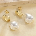 Baroque irregular gold metal earrings with white pearls on luxury silk background - Gold Baroque Irregular Pearl Drop Earrings