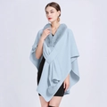 Light blue knitted poncho with faux fur collar and decorative pompom details - Pale Blue