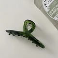 Detailed top view of a translucent green marbled acetate hair claw clip on white background - Hanger Shape