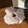 Macro detail of a pale pink scrunchie with button accent on a dark wooden surface - Light Pink Bowknot Button Scrunchie