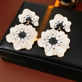 Close-up of vintage ginkgo flower earrings with white petals and black dots on a leather box - 77# Silver Pin-Gold-Black-White