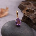 Elegant pear-cut amethyst pendant with gold prong setting on a natural grey pebble - Natural Amethyst Water Drop Pendant Gold