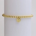 Detailed shot of golden bead bracelet featuring a round pendant engraved with letter Z - Letter Z (DB240603-Z)