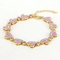 Detail of gold-plated bracelet featuring purple enamel hearts and sparkling zircon stones - Purple