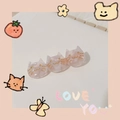 Detail of three connected pink translucent cat-shaped hair clips with gold accents - Sakura Pink Cat