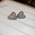 Macro detail of silver heart earrings with ice-crackled blue gradient crystal - Heart Shaped Wrinkled Crystal Style / Silver