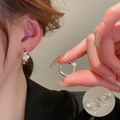 Elegant silver pearl hoop earrings with a twisted design and a lustrous white finish - Silver Twisted Pearl