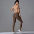 Detail of coffee brown seamless yoga set featuring cross back bra and high waist leggings - Brown