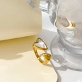Detailed shot of golden heart open ring with white mother of pearl inlay on beige paper - US 6 / Double Heart Open