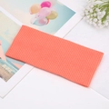 Detailed macro view of coral orange ribbed knit texture on soft elastic headband - Orange