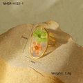 Vista macro de un anillo dorado ajustable con flores secas naturales verdes y naranjas - Estilo Ovalado Con Flores Secas Verdes y Naranjas (NMSR-H125-1)