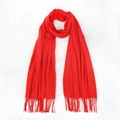 Soft red faux cashmere scarf with elegant tassels displayed on a plush white surface - Red