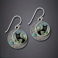 Vintage silver cat earrings with blue gemstone accents and yellow-eyed cat artwork - Antique Silver