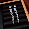 Close-up of silver tassel earrings with square cubic zirconia in a black velvet box - Long Geometric Tassel Style / White Zirconia - Silver
