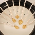 Elegant freshwater pearl necklaces with various gold pendants on a decorative tray - No.2 Square Butterfly