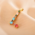 Macro shot of gold letter L pendant with colorful inlaid zircon stones on beige fabric - Letter L