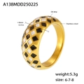 Detailed close-up of golden stainless steel ring with black and white checkerboard pattern - US 6 / Gold