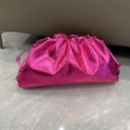 Detailed view of pink metallic cloud clutch bag with textured pleats on marble floor - Large (37x20x9cm) / Rose Red
