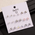 Detailed set of nine assorted studs including silver hearts, roses, and pearls on a white card - Silver Heart Pearl Zircon Earrings (E0216-1)