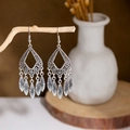 Artistic detail of vintage silver drop earrings with leaf fringe hanging on a branch - E2874-9/Leaf Hollow Teardrop
