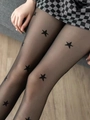 Detail of sheer black tights featuring a star print pattern with a plaid skirt - One Size / Star Pattern Fashion Black Sheer Tights