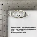 Detail view of silver alloy handcuff link with Freedom text on a scale ruler - Large / Antique Silver