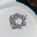 Detalle de broche de flor en oro de 18k con perlas gris oscuro y circonitas brillantes - Plateado Gris