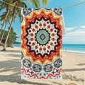 Double-sided microfiber beach towel with colorful mandala patterns hanging on a palm tree - B105-Geometric Mandala Multicolor