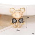 Macro detail of bear-shaped shoe charm with champagne stone and gold finish, 3cm height - C481 Heart Bear Grey