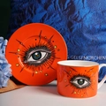 Artistic ceramic coffee cup and saucer set with orange eye and star patterns - Orange Eye
