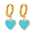 Close-up of gold heart earrings with sparkling blue glitter pendants on white background - Gold with Blue