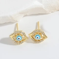 Detailed close-up of golden evil eye stud earrings with blue and white zircon accents - Blue Eye