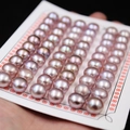 Lustrous round pink purple freshwater bread pearls arranged on a white display card - 9.5-10.0mm (54pcs/Card) / Lavender