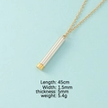 Nesting cylinder pendant necklace with gold chain and silver body on light blue background - Steel Shell + Gold Inner Column (MP381)