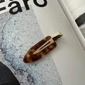 Macro detail of tortoiseshell acetate hair clip with premium gold metal clamp finish - No-Crease Hair Clips / Brown
