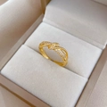 Polished gold plated wavy crisscross ring with cubic zirconia on velvet background - Adjustable Open / Gold Twisted Micro Pave Style (J0118)