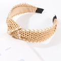 Close-up detail of the woven raffia headband showing a knot design and satin lining - Tan
