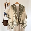 Beige cashmere-feel scarf with olive green floral pattern and fringe in lifestyle setting - Fresh Floral-Green