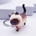 Detailed close-up of a realistic Siamese cat keychain with resin texture and metal ring - Brown