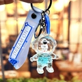 Portachiavi astronauta blu con bottiglia di sabbie mobili e cinturino in silicone - Astronauta dell'Oceano Blu - Viso Nero in Piedi