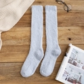 Light blue coral fleece knee-high socks for winter with soft plush texture on wood background - Gray Blue